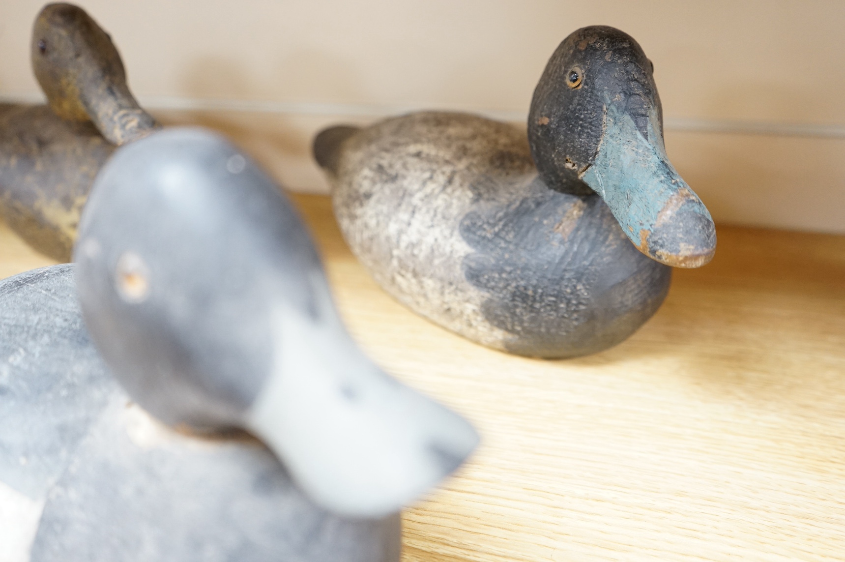 A group of four 19th and 20th century wooden decoy ducks, largest 39cm wide. Condition - fair